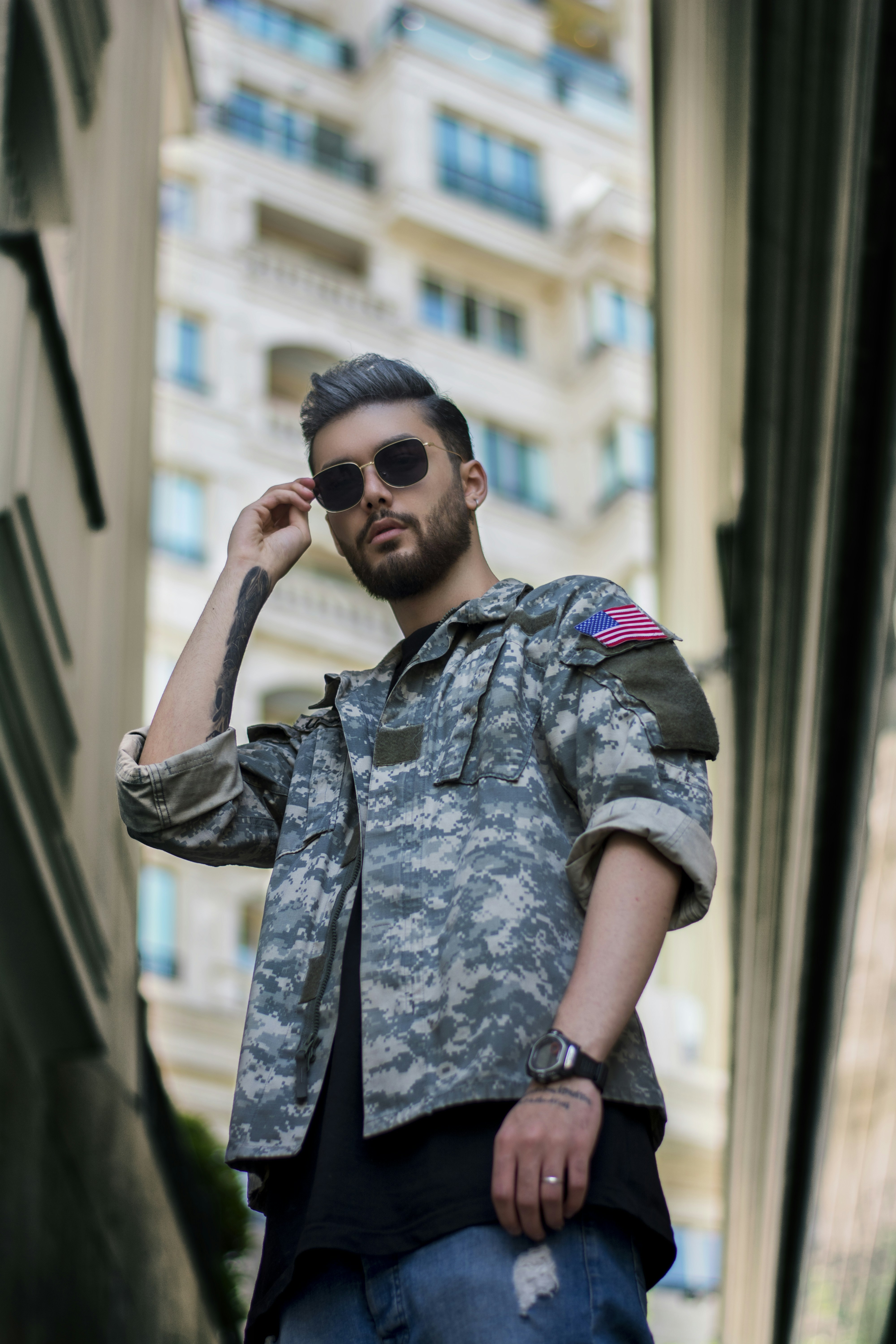 man in green and black camouflage uniform wearing black sunglasses