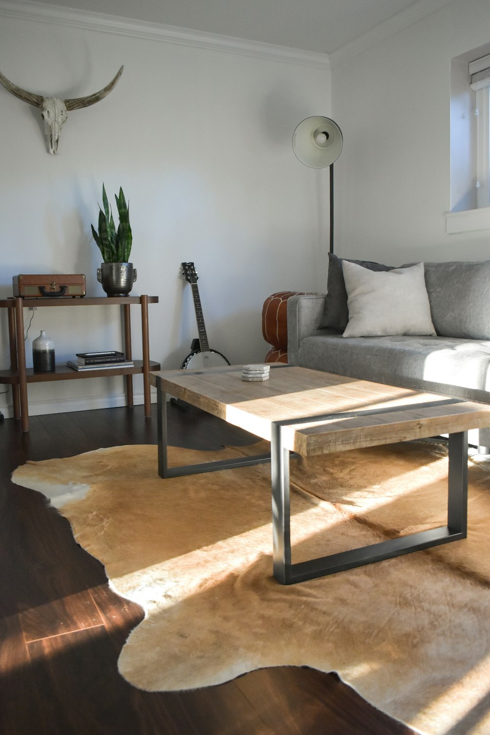 brown wooden table near white sofa