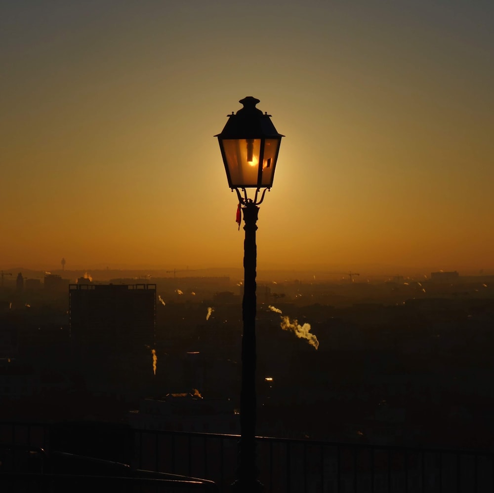 black street lamp during sunset