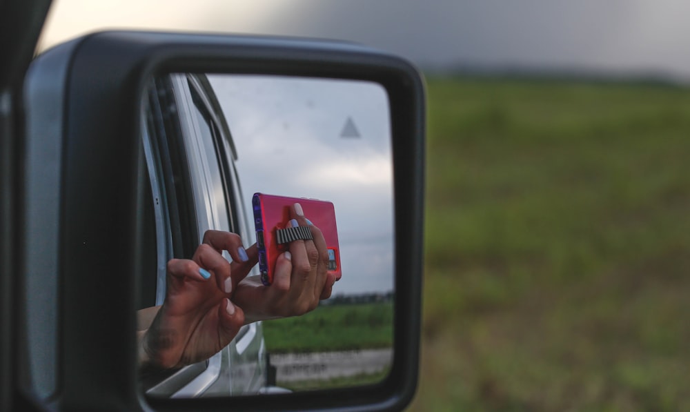 person holding red card in car