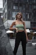 A model wearing a sustainable outfit in an urban environment.