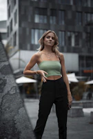Model wearing a matching set of relaxed-fit pants and a cropped hoodie, walking confidently down a city street.