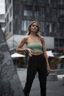 A stylish woman confidently posing in a chic urban setting.