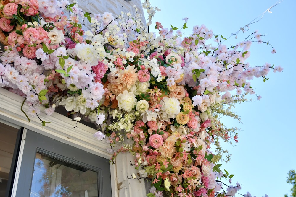 白い木製の窓にピンクと白の花