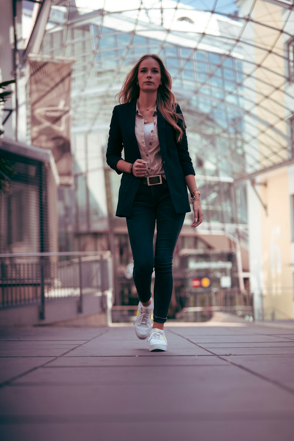 woman in black blazer and black pants standing on gray concrete floor during daytime