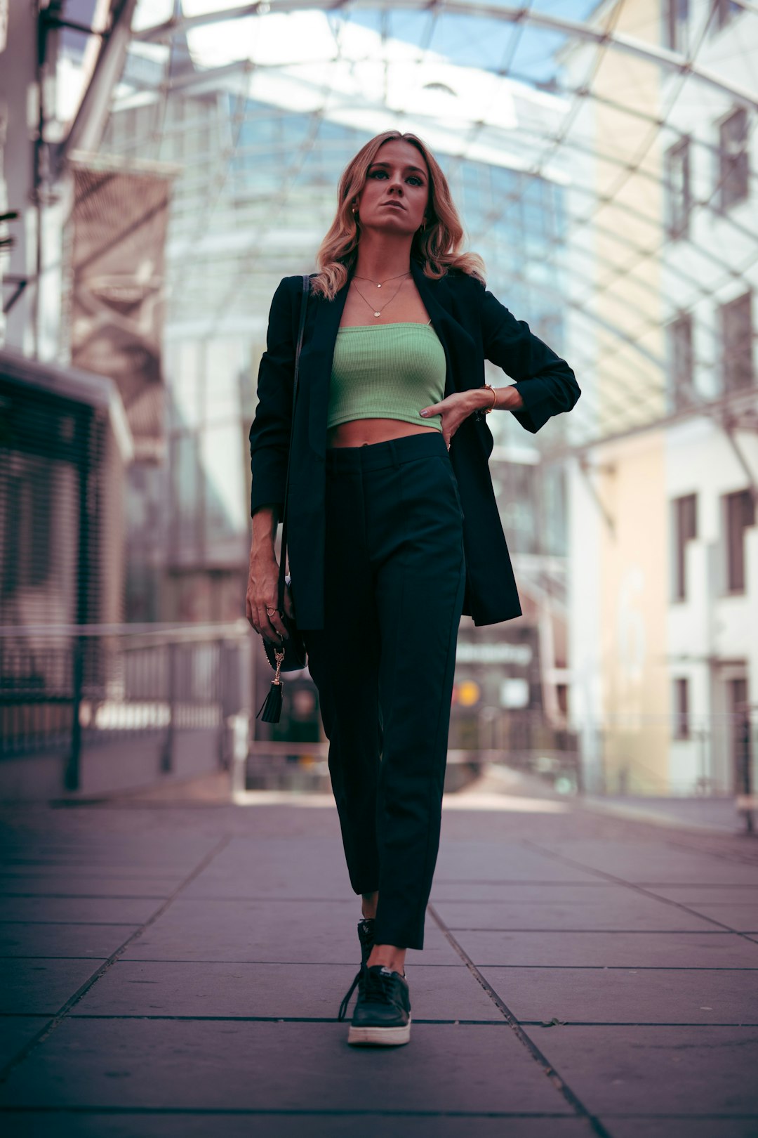 woman in black blazer and black dress pants standing on sidewalk during daytime