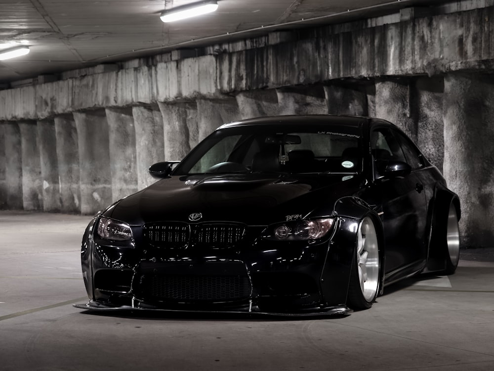 black bmw m 3 coupe parked on gray concrete bridge during daytime