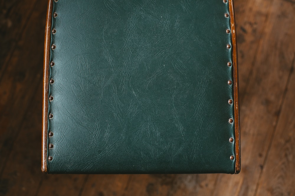 green leather wallet on brown wooden table