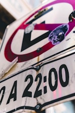 A close-up of a neighborhood street sign with a subtle shadow of a suspicious figure in the background.