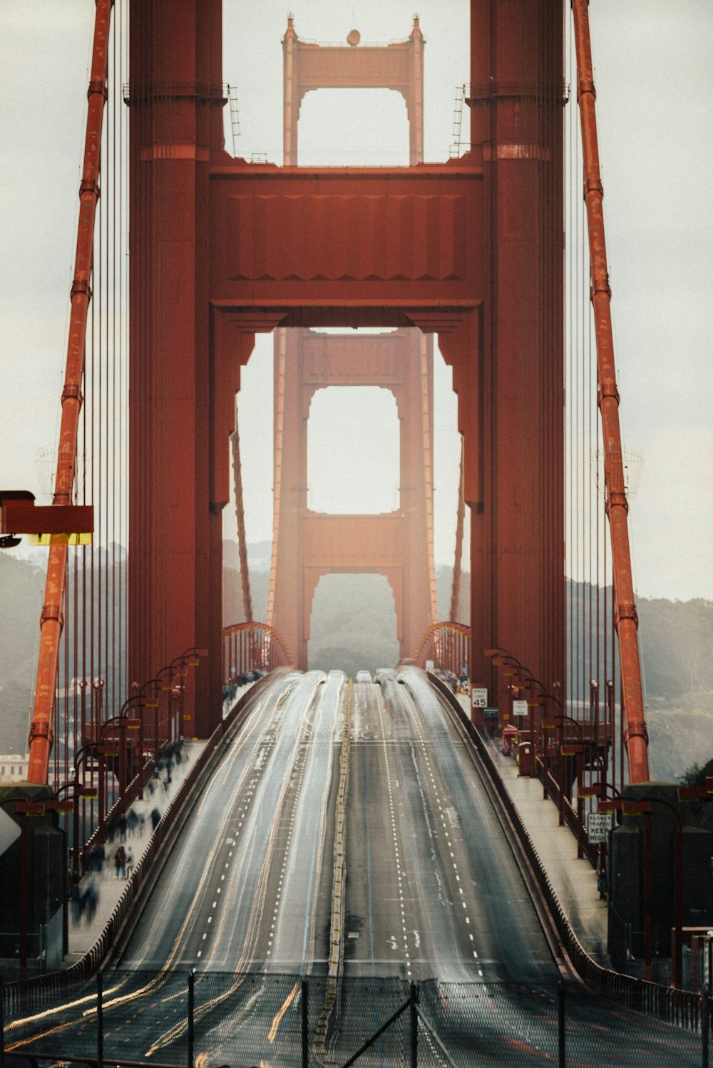 red bridge with white car during daytime