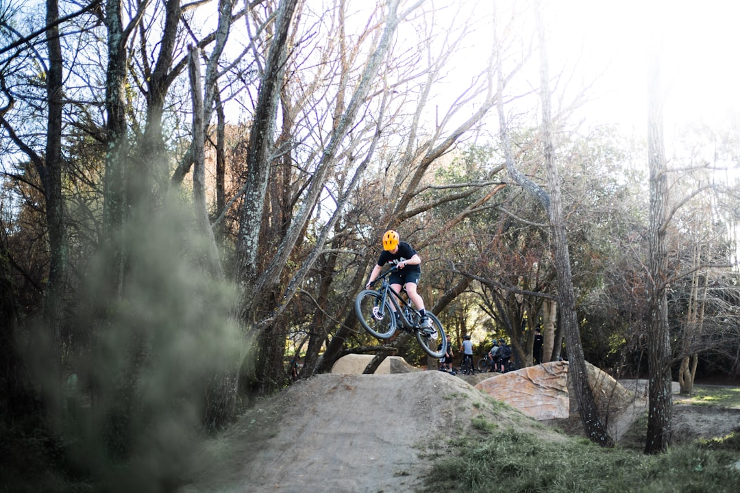 man riding motocross dirt bike on rocky road during daytime