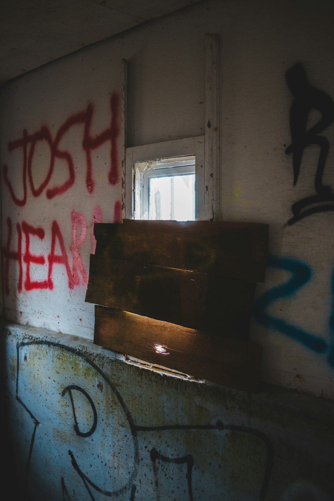 brown wooden cabinet near window