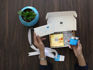 person holding white and blue plastic cup