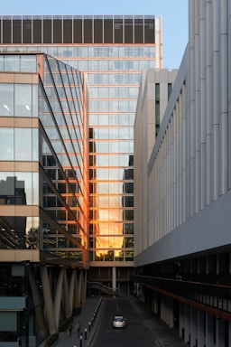 Downtown office building with reflective glass windows in golden hour light.