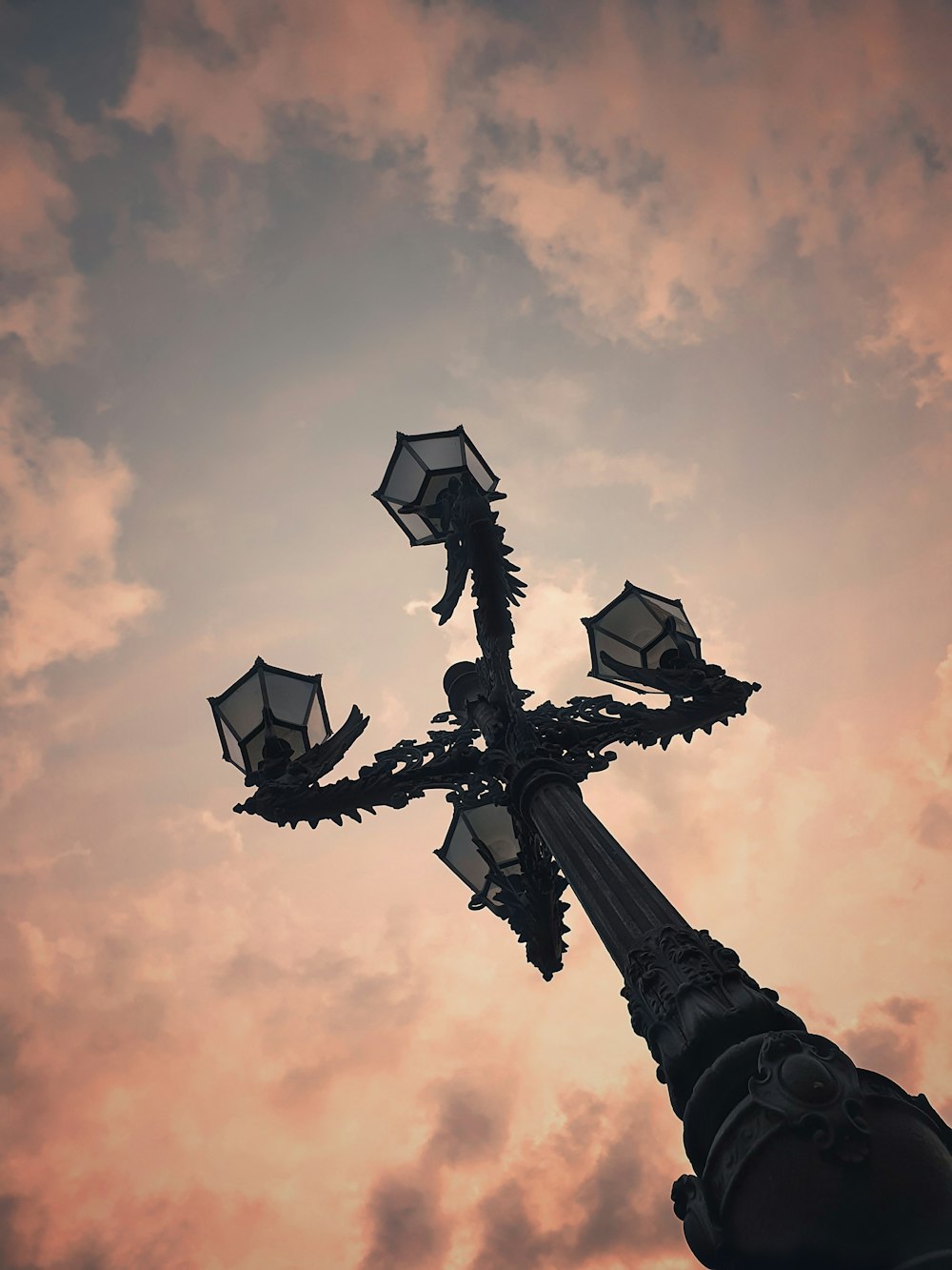 a street light with a cloudy sky in the background