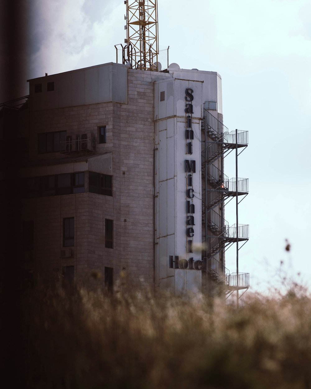 a tall building with a crane on top of it