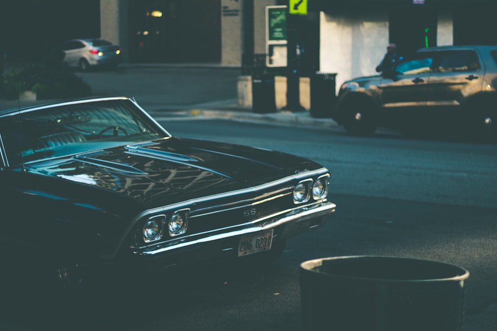 black chevrolet camaro on road during daytime