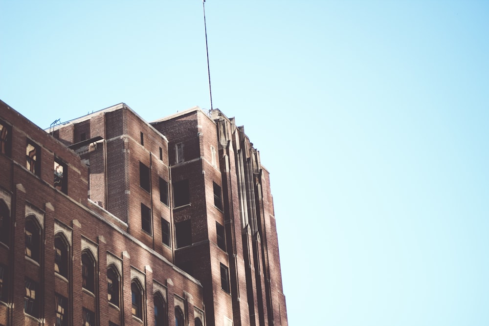 a tall building with a flag on top of it