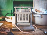 Close-up of a vintage-style toaster gleaming on a rustic wooden countertop.