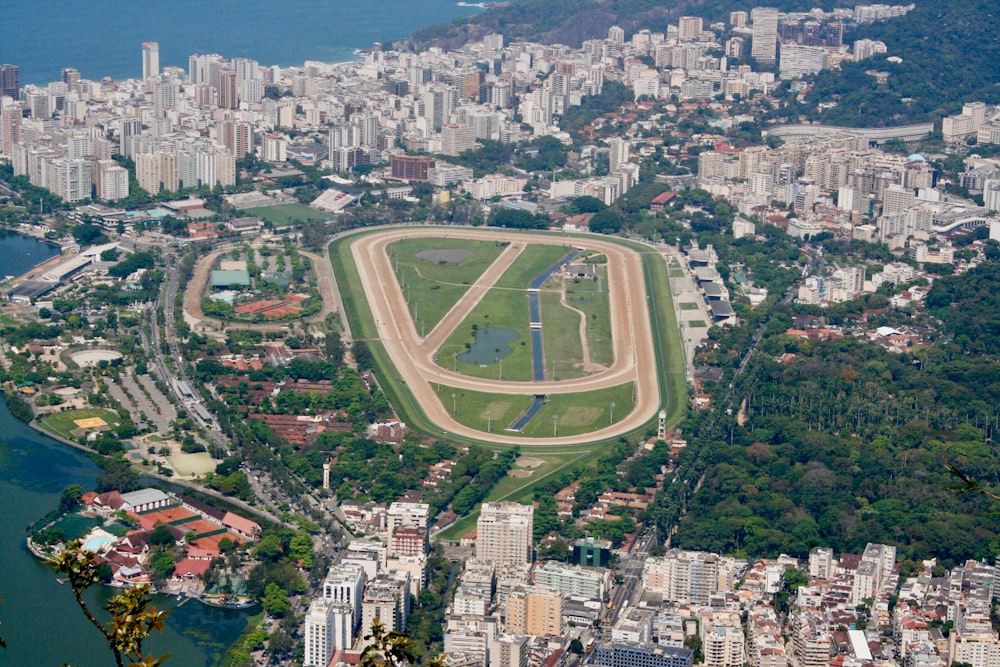 aerial view of green field and city during daytime