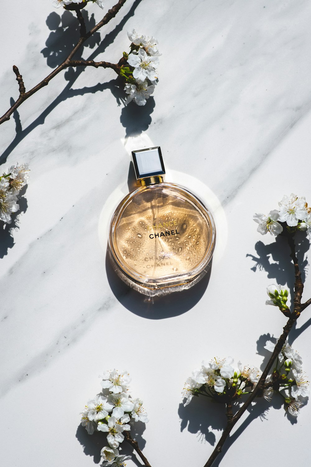 a bottle of perfume sitting on top of a white table