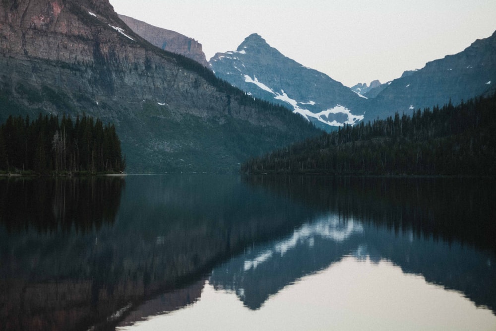 a mountain range is reflected in a lake