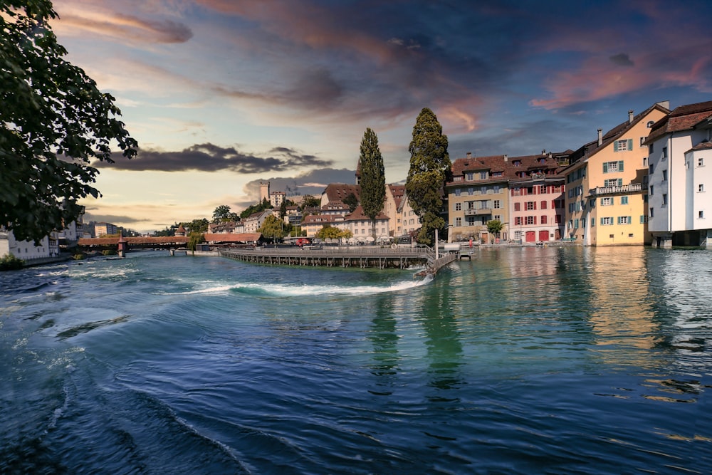 body of water near city buildings during daytime