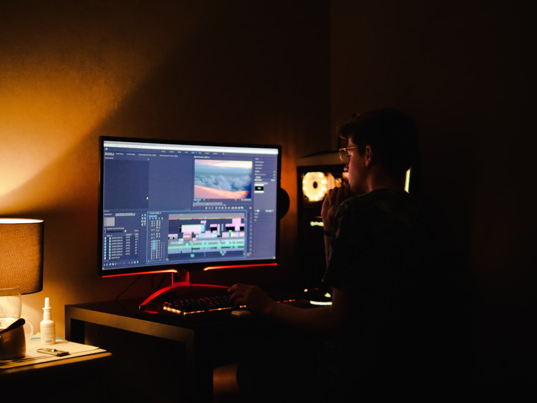 woman in black shirt sitting in front of computer