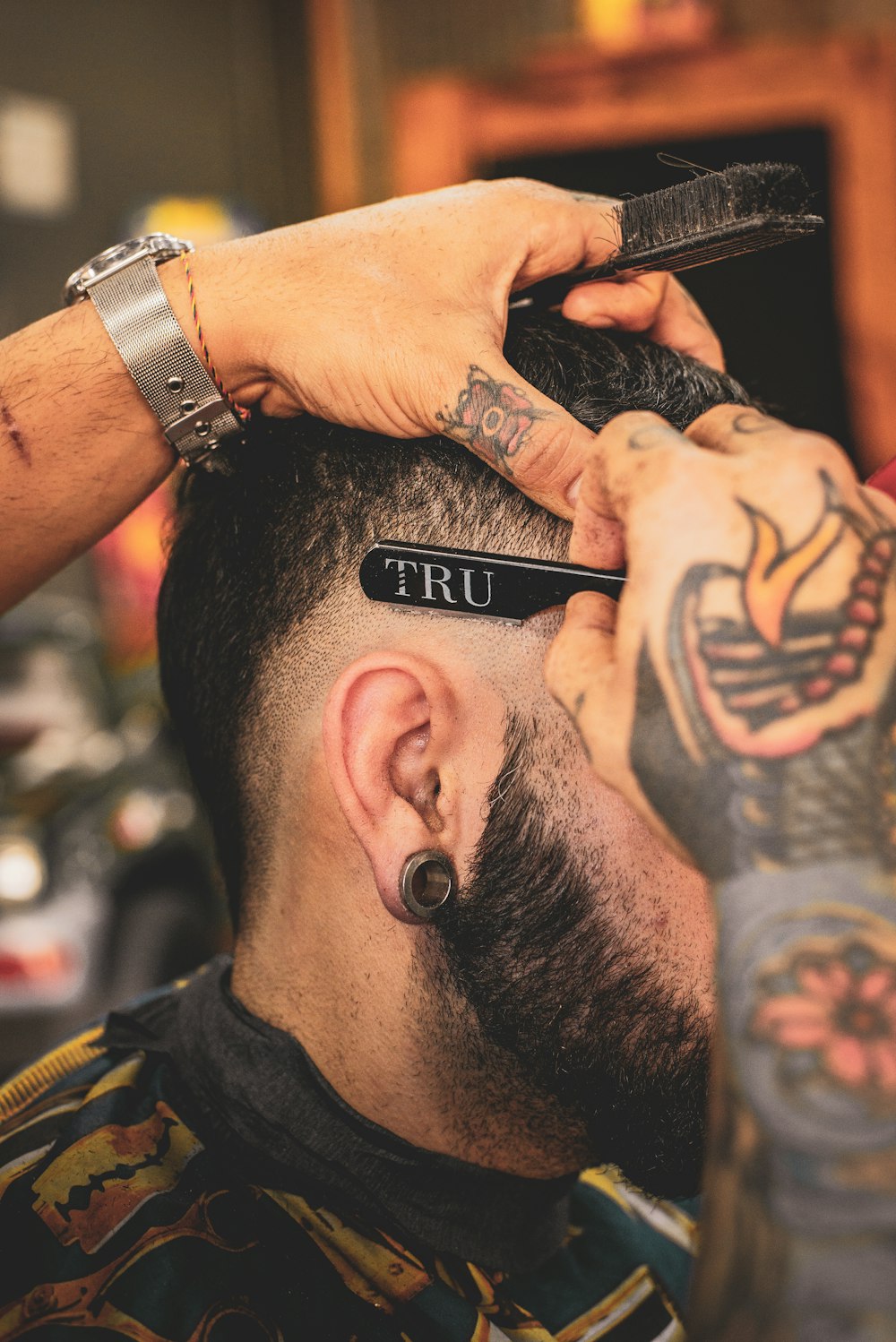 man in black shirt with tattoo on his left arm