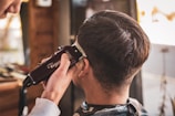 man in white dress shirt holding black dslr camera