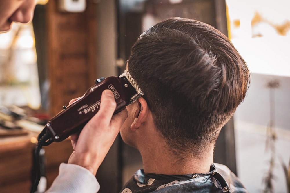 man in white dress shirt holding black dslr camera