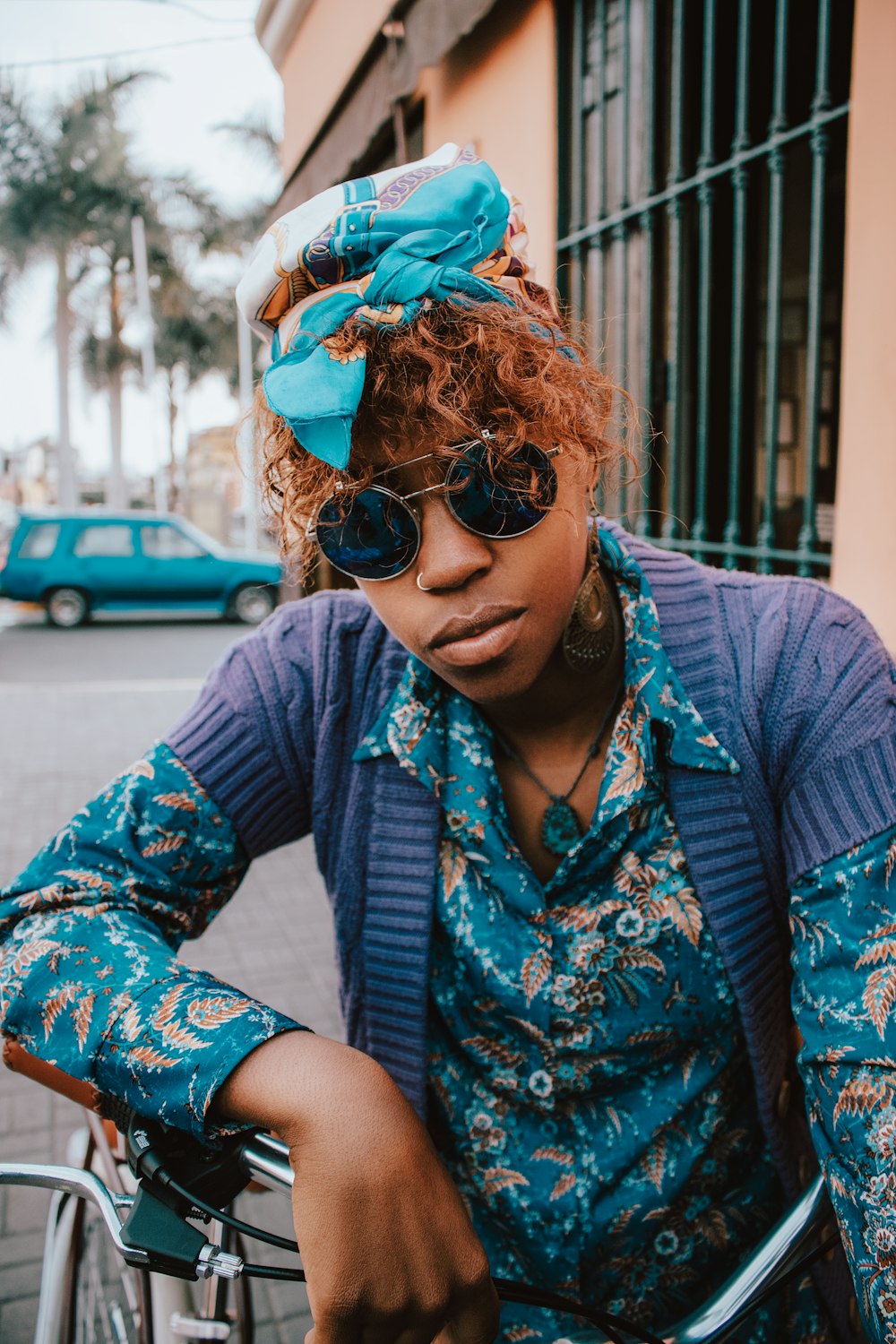 woman in blue and white floral dress wearing black sunglasses