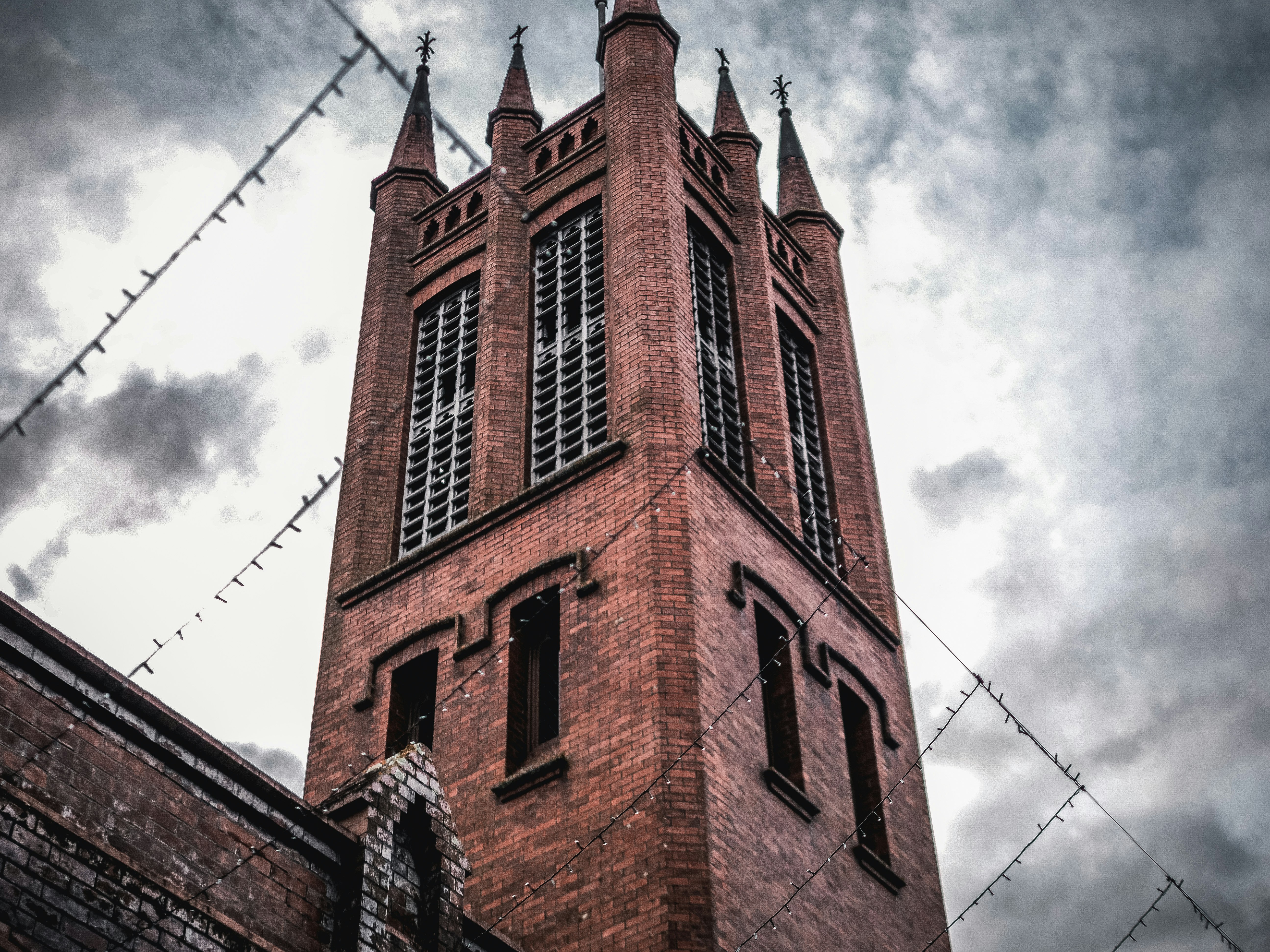 brown concrete building under white clouds during daytime