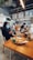 A cozy cafe setting with patrons enjoying nutritious meals and drinks post-workout.