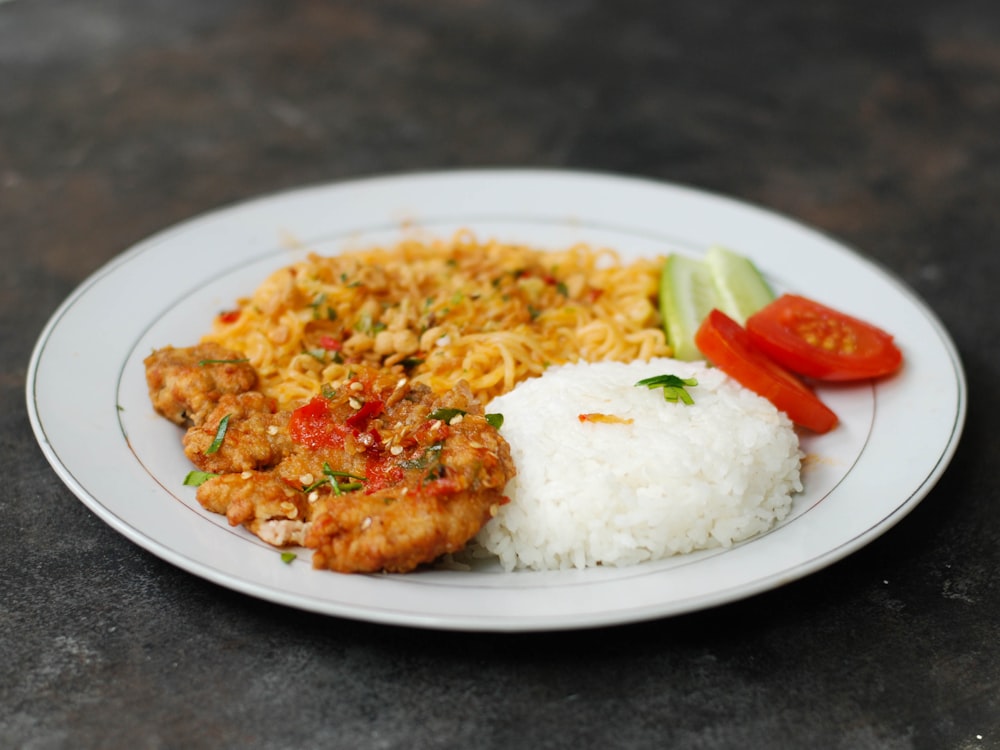 rice with sliced tomato on white ceramic plate