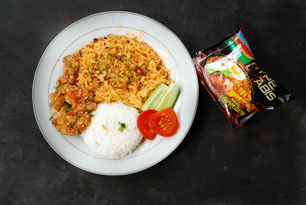 rice with sliced tomato and cucumber on white ceramic plate