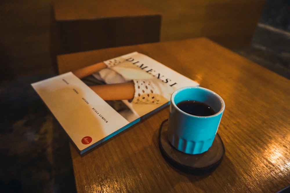 blue ceramic mug on brown wooden table