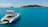 Luxury catamaran sailing smoothly in turquoise Caribbean waters under clear blue sky.