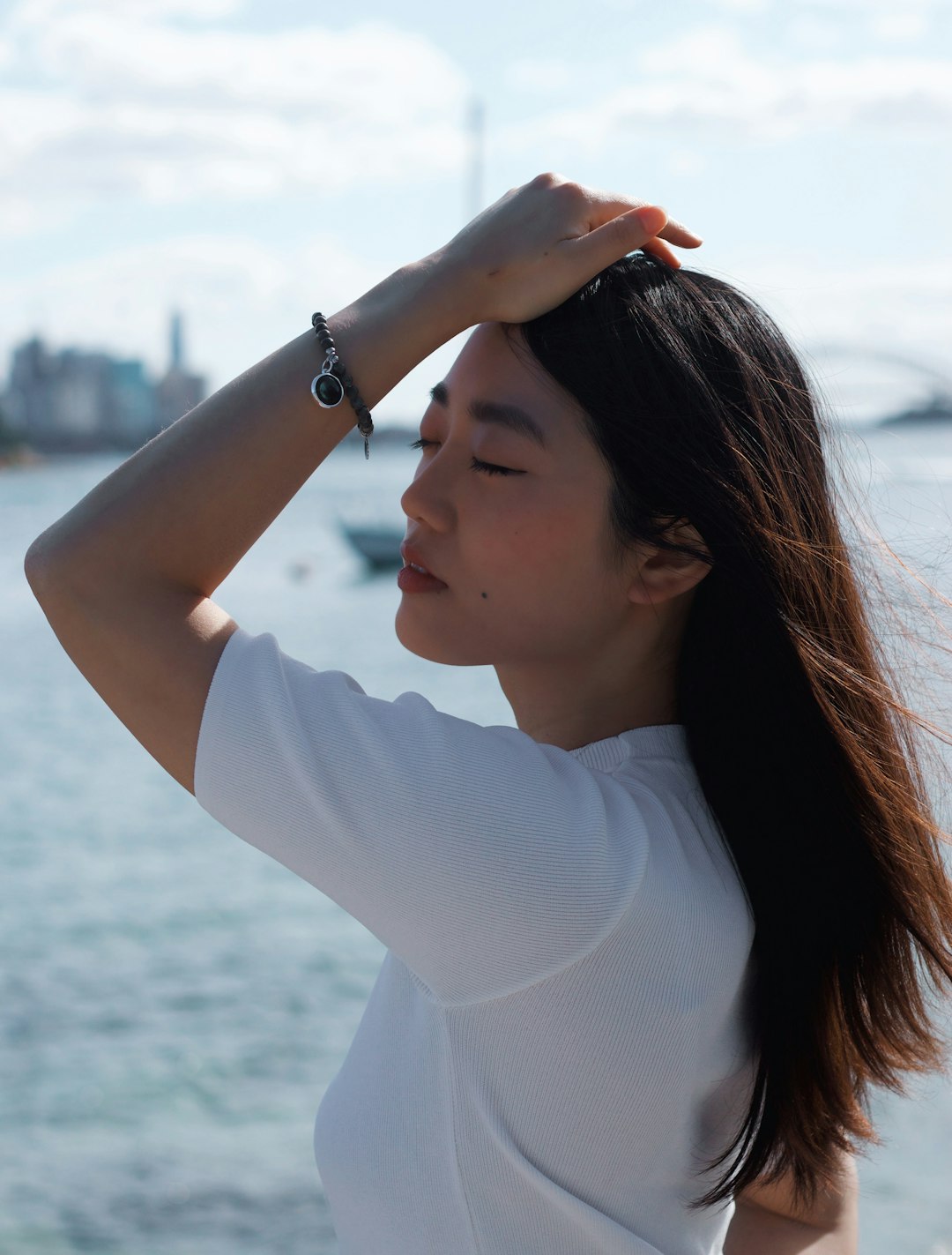 woman in white long sleeve shirt wearing silver bracelet