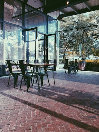 Modern cafe with automatic glass walls opening to a sunny terrace