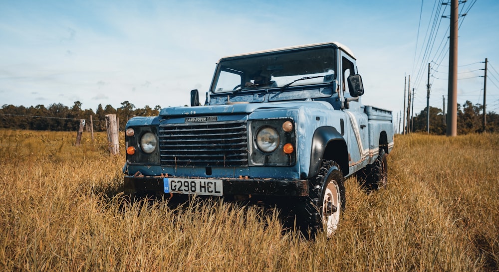 blue jeep wrangler on brown grass field during daytime