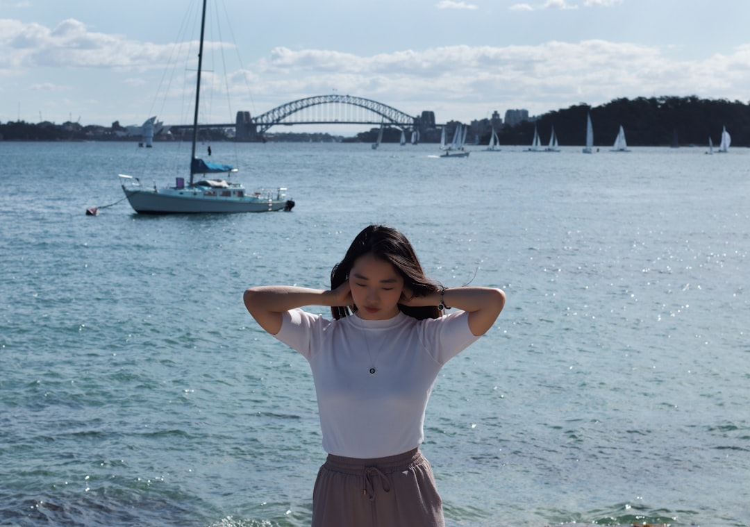 woman in white shirt and maroon skirt standing on beach during daytime