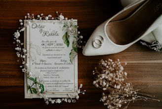 white and green greeting card on brown wooden table