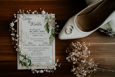 white and green greeting card on brown wooden table