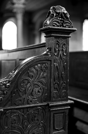 Close-up of the intricate wooden carvings on the church pews, reflecting rich heritage.