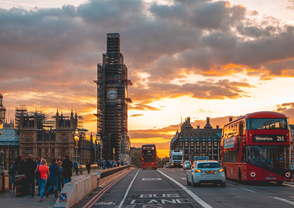 cars on road near buildings during sunset