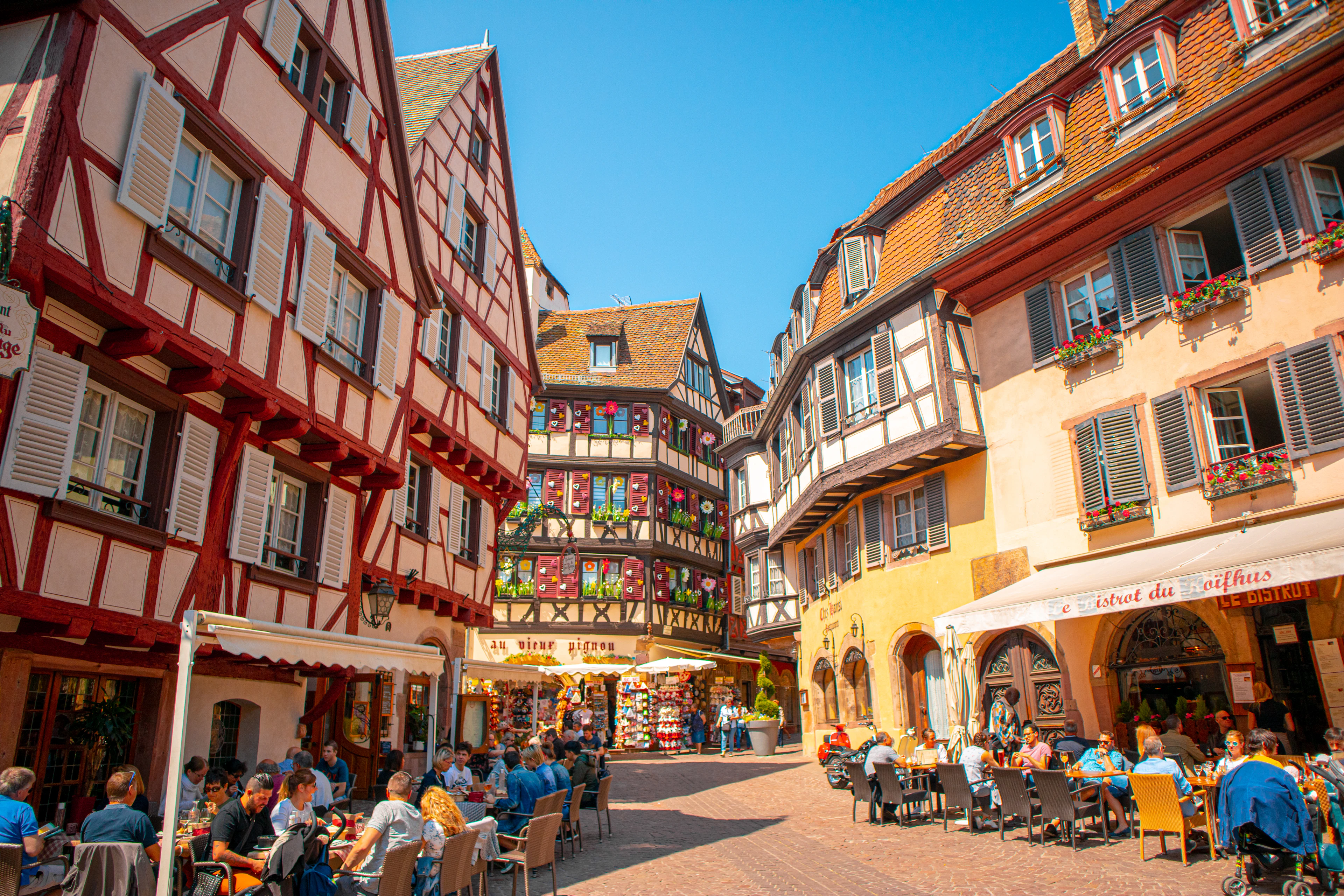 Half-timbered houses and cafe terraces around a square in Strasbourg