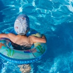 woman in blue swimming cap in pool