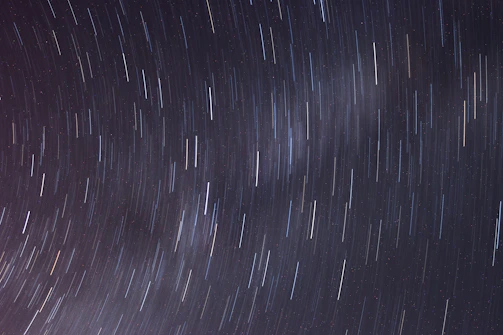Time-lapse photo showing star trails circling around the North Star.