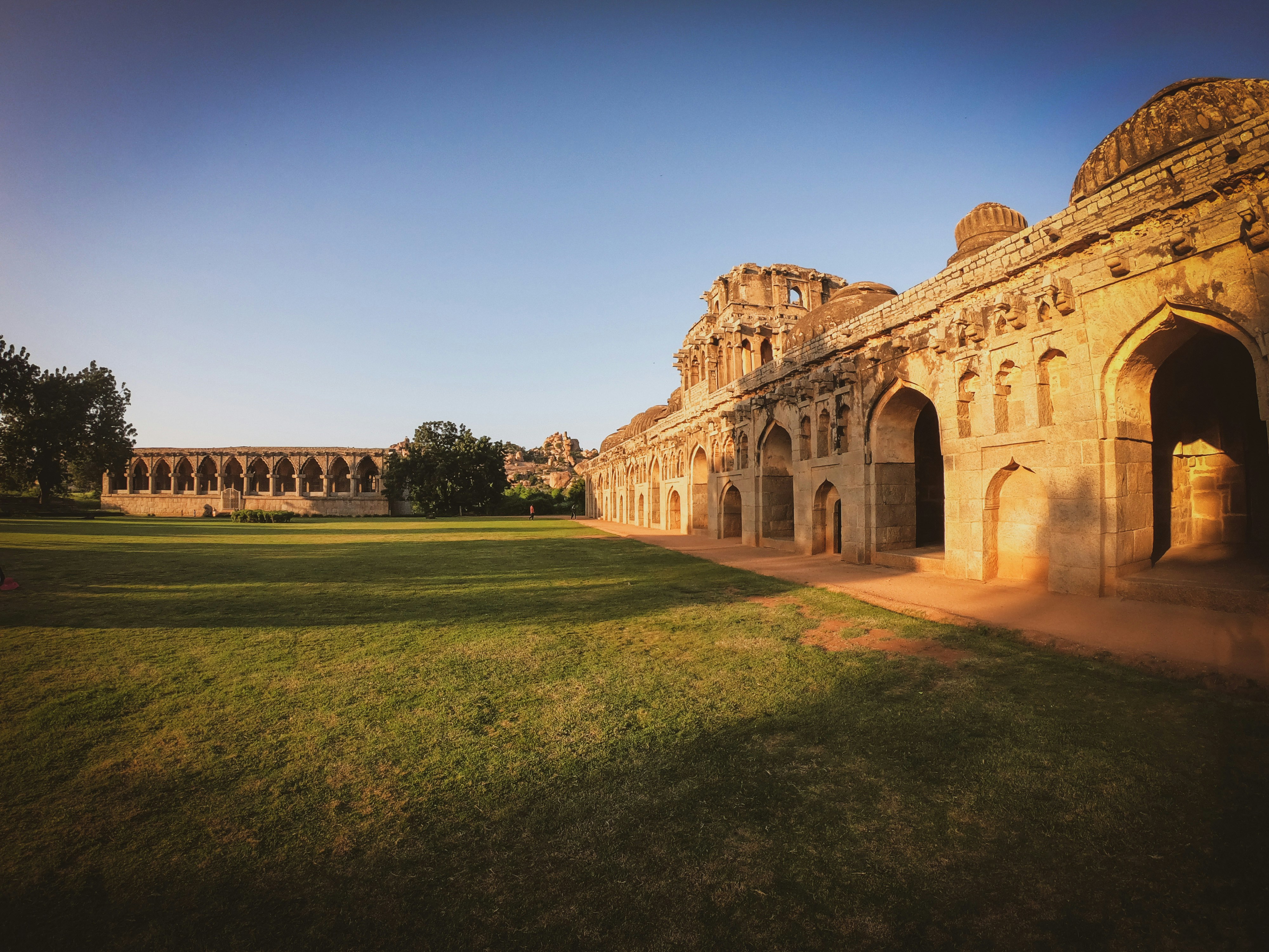 brown concrete building near green grass field during daytime